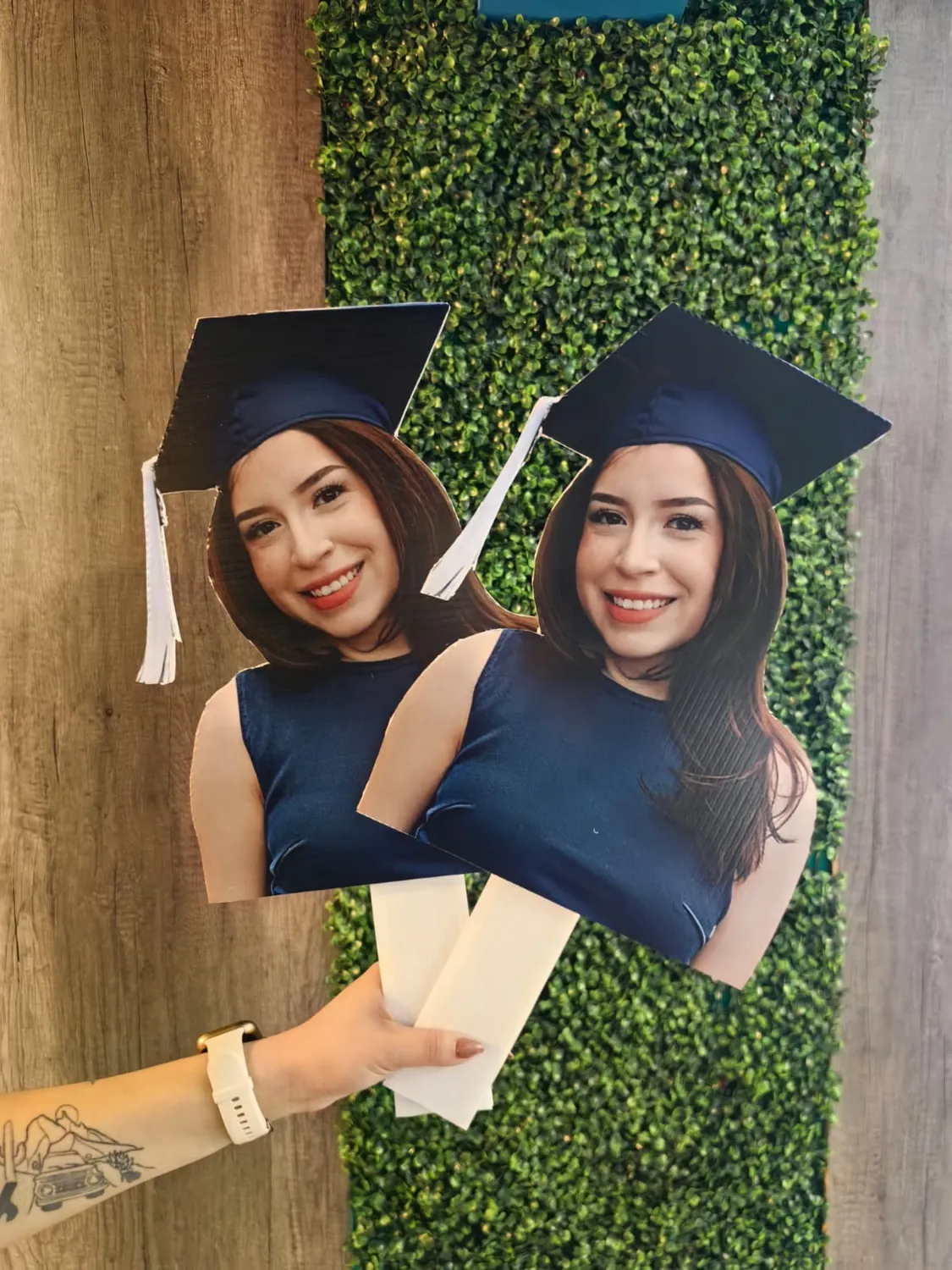 Dos siluetas impresas y recortadas de una graduada con toga y birrete